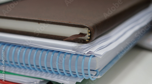 Stack of paperwork and notebook
