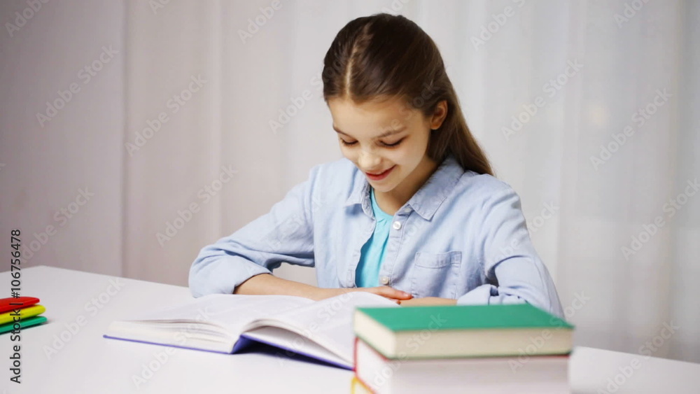 happy school girl reading book or textbook at home happy school girl reading book or textbook at home