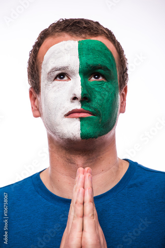 Pray for Northern Ireland. Northern Irishman football fan pray for national team on white background. European 2016 football fans concept. photo