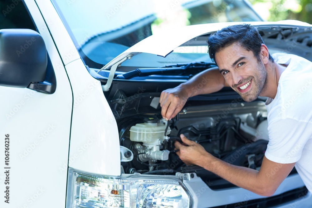 Portrait of happy mechanic fixing van Portrait of happy mechanic fixing van