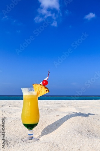 Fruity cocktail is on a beach
