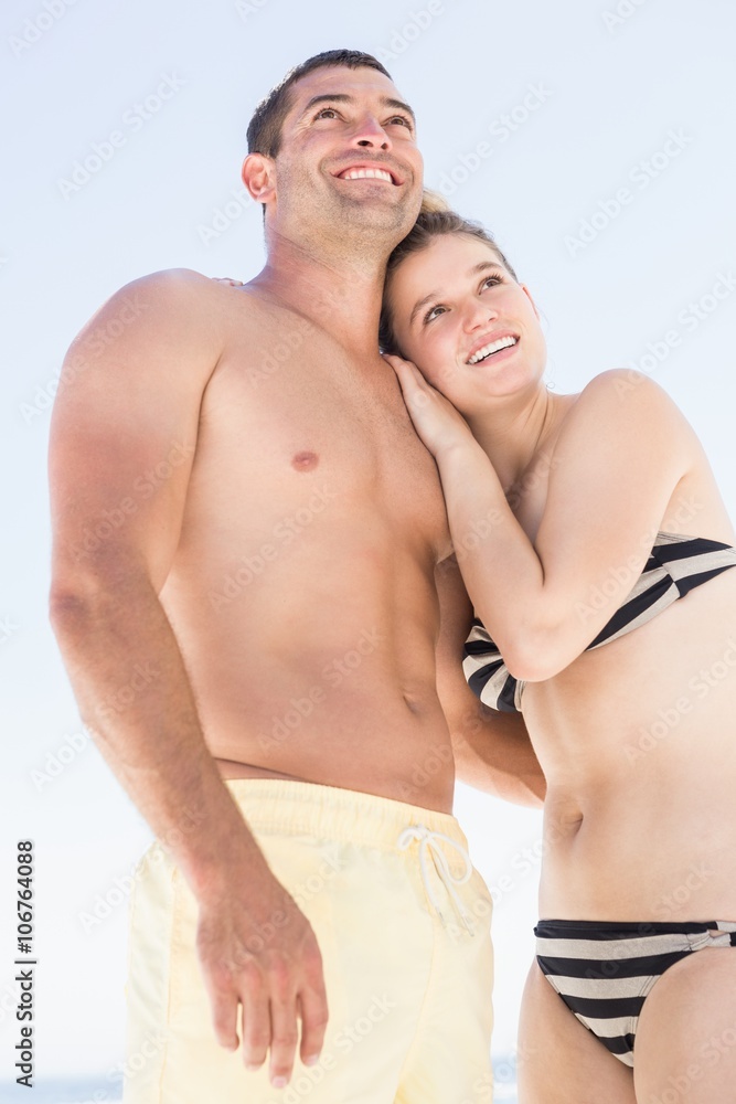 Smiling couple embracing on the beach Smiling couple embracing on the beach