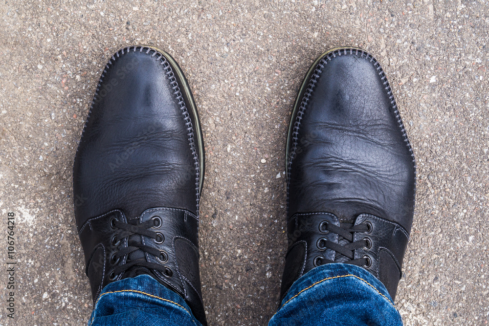 Black shoes on his feet Black shoes on his feet