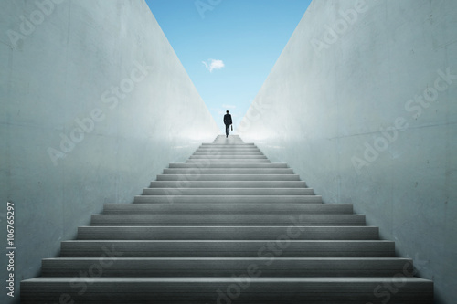 Fotografie, Obraz Ambitions concept with businessman climbing stairs