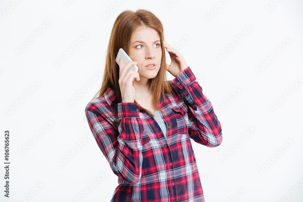 Pensive woman talking on the phone Pensive woman talking on the phone