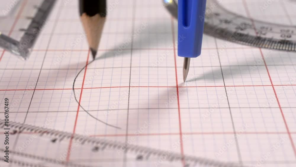 Drawing a circle with a compass. A geometry set of a compass and set ...