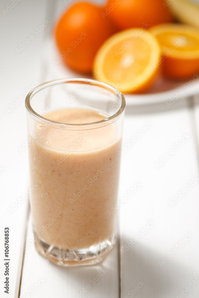 Healthy drink orange and banana smoothies on wooden table Healthy drink orange and banana smoothies on wooden table