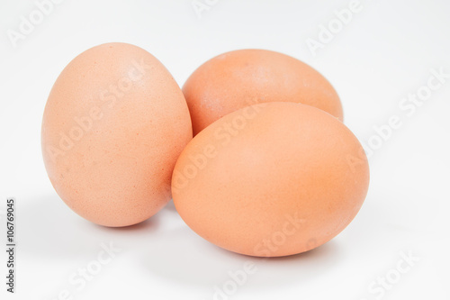 Three chicken eggs on a white background