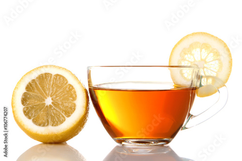 delicious green tea in transparent Cup near the cut lemon on a white isolated background