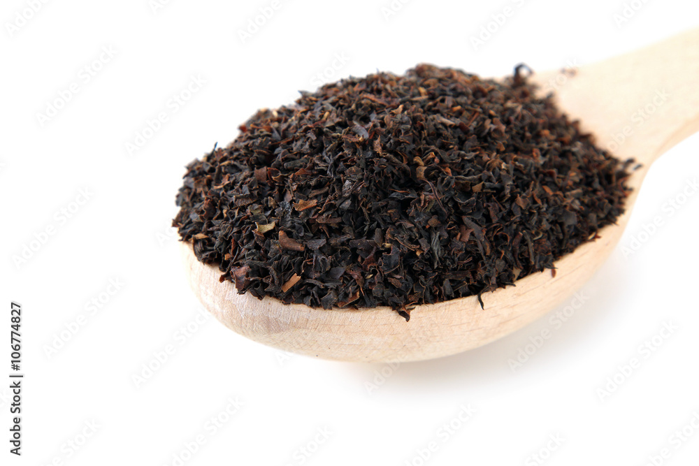 wooden spoon full of loose tea on white isolated background wooden spoon full of loose tea on white isolated background