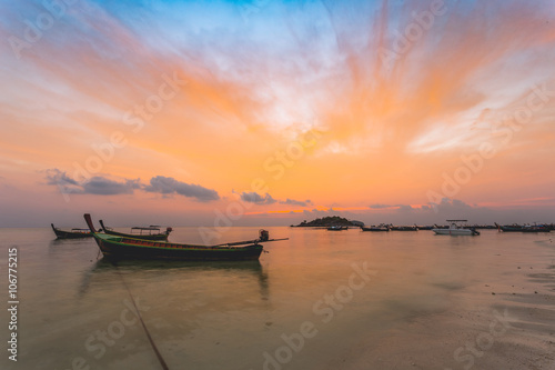 Anchored boats moored on the beach. twilight sunrise clouds