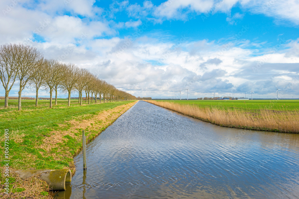 Canal through a blue cloudy landscape 