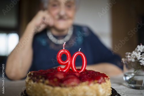Candles on a birthday cake of a senior woman celebrating her ninetieth birthday photo