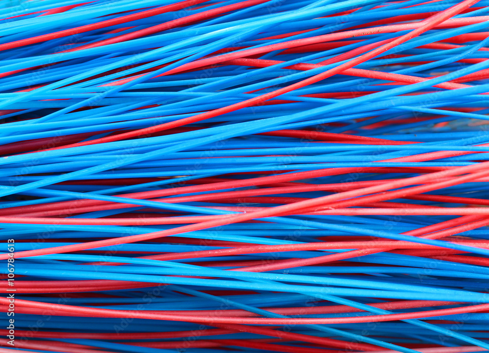 Colorful red and blue stems of plastic broom closeup