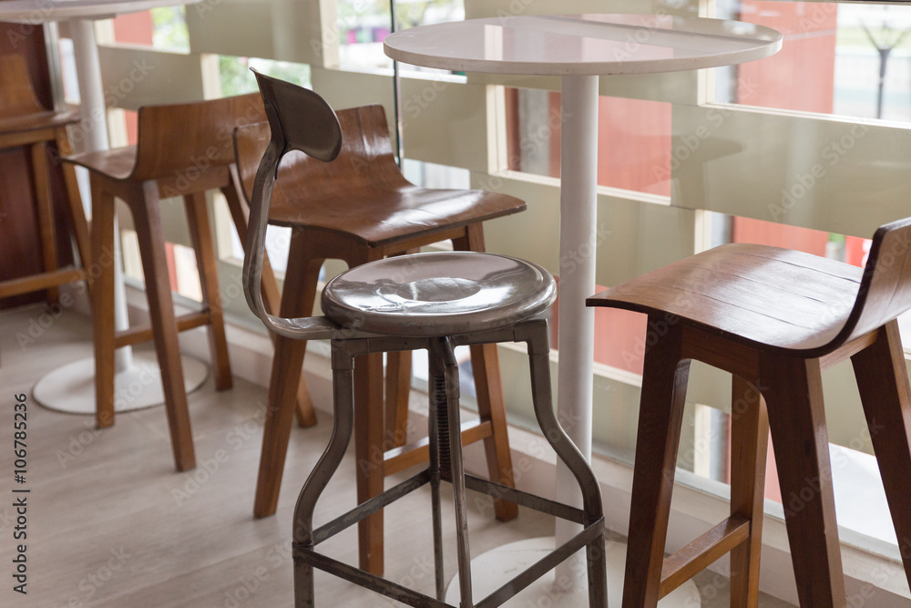 metal and wooden stool with round table at the balcony metal and wooden stool with round table at the balcony