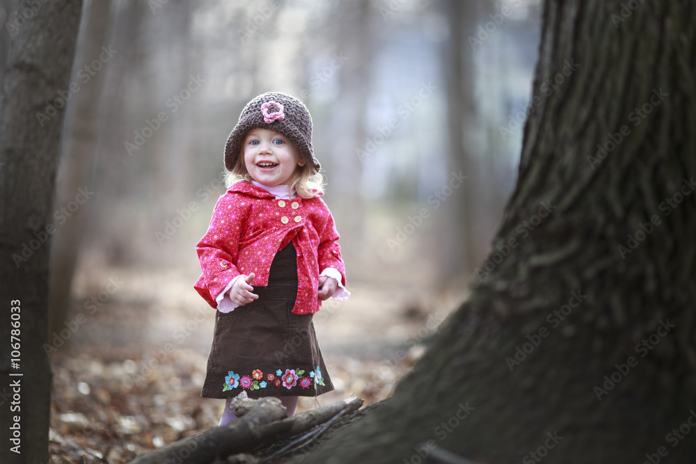 happy little child, baby girl laughing and playing in the fall outdoors