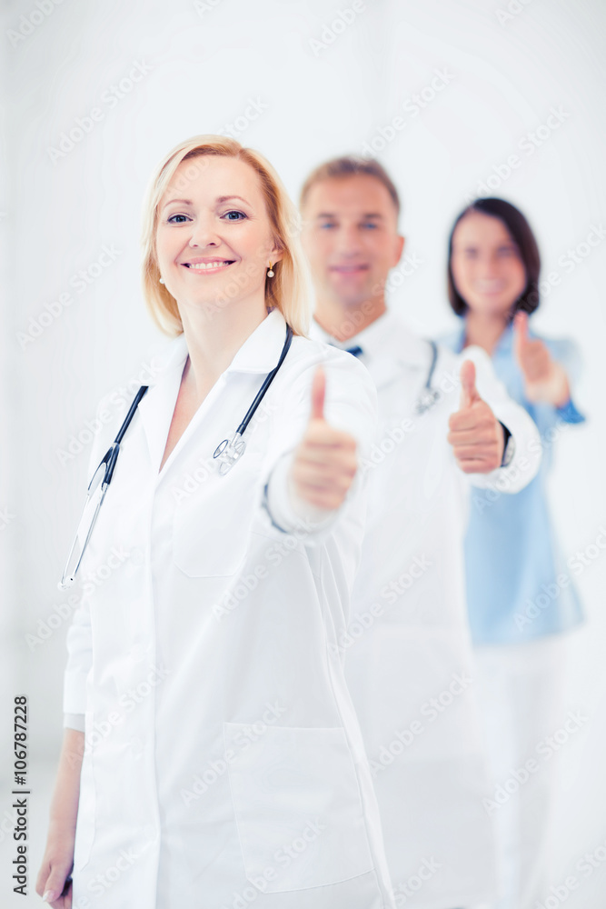 team of doctors showing thumbs up team of doctors showing thumbs up
