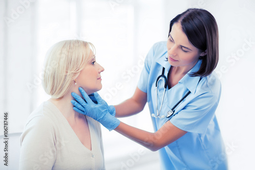 plastic surgeon or doctor with patient