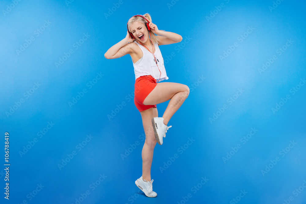 Female teenager listening music in headphones