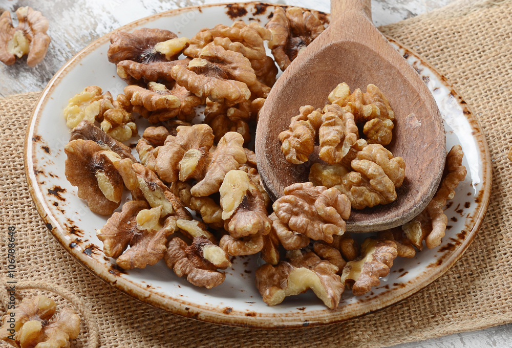 Walnuts on a wooden spoon