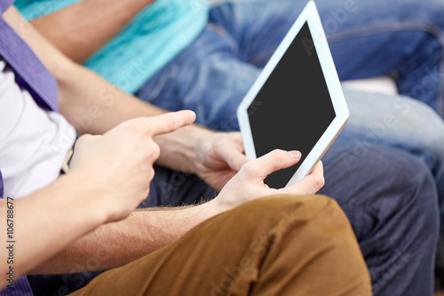 close up of male hands with tablet pc at home