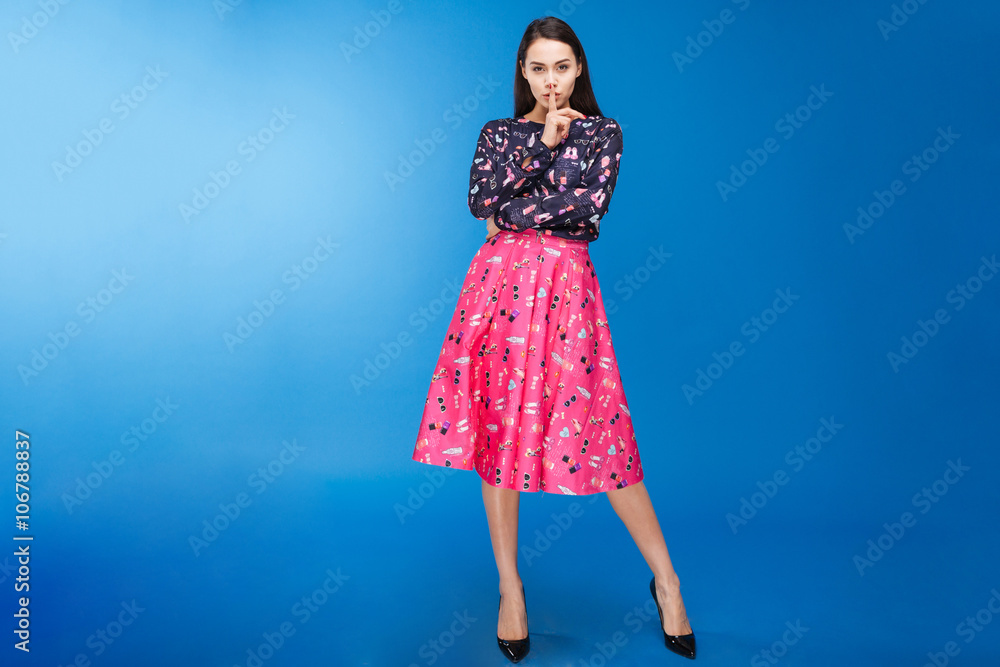 Charming woman showing finger over lips Charming woman showing finger over lips