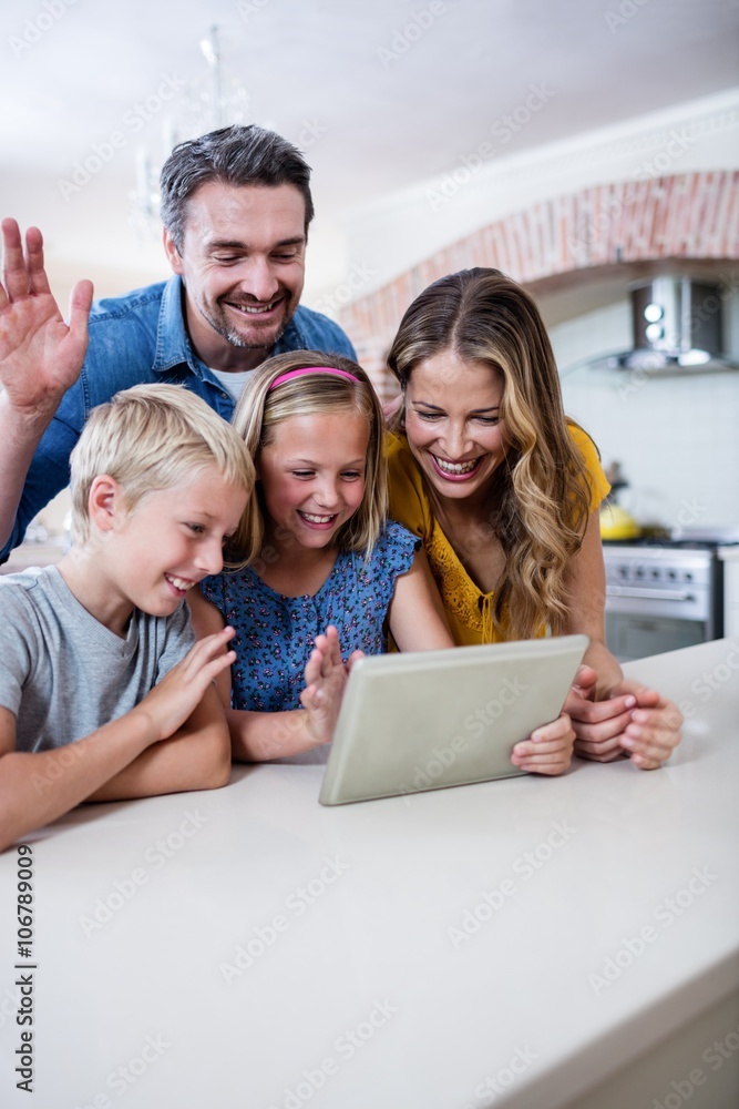 Parents and kids using digital tablet in kitchen Parents and kids using digital tablet in kitchen