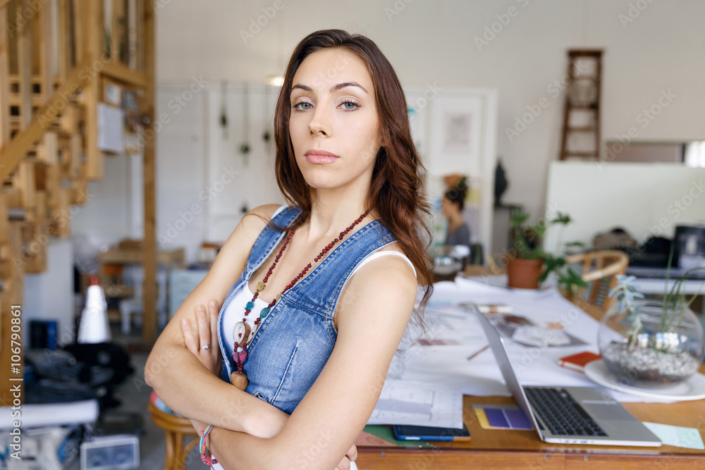 Young woman standing in creative office Young woman standing in creative office