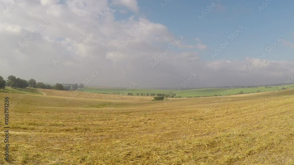 The descent over the meadow from a blue sky and clouds The descent over the meadow from a blue sky and clouds