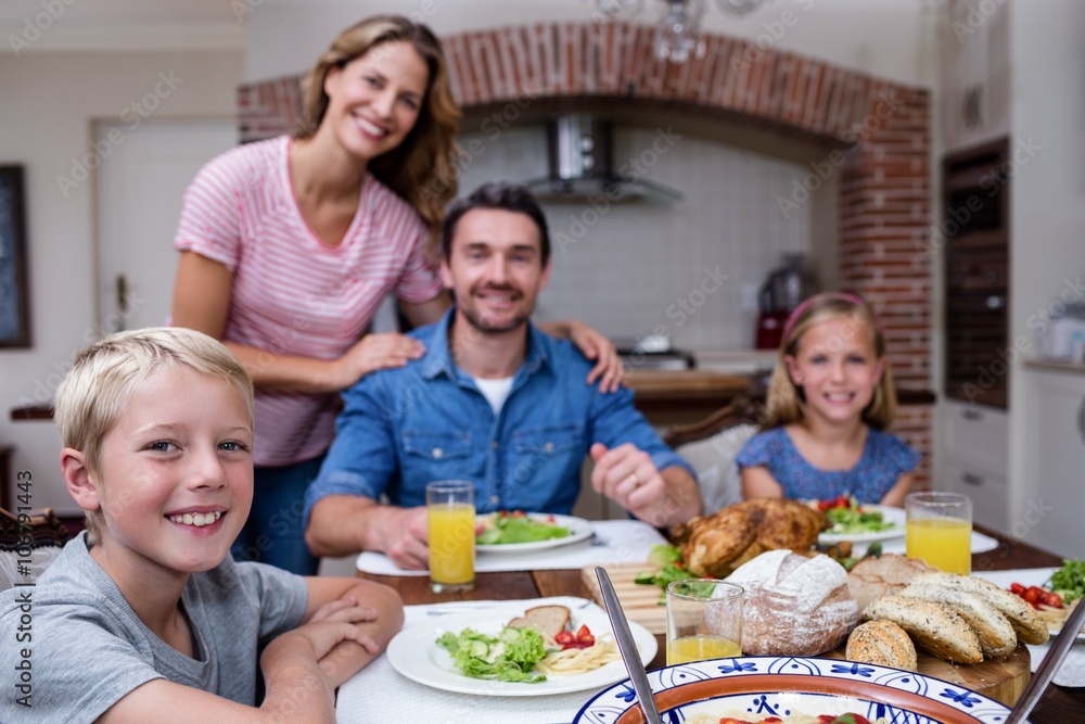 Portrait of happy family having meal in kitchen Portrait of happy family having meal in kitchen