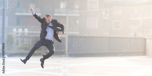 Dynamic businessman jumping outdoor