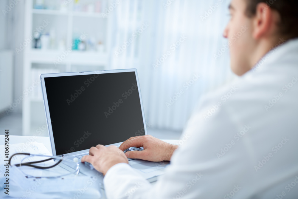 Doctor in the office using a computer Doctor in the office using a computer
