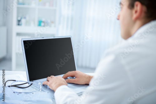 Doctor in the office using a computer