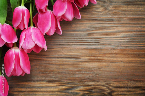 Fresh pink tulips on a wooden table  top view