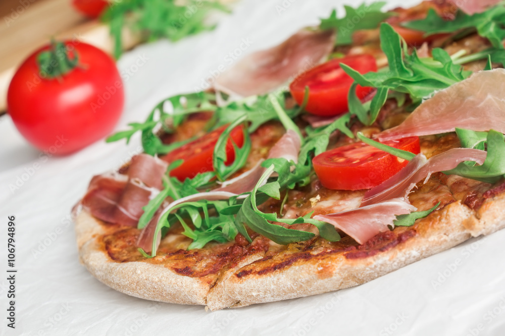 Pizza with Porsciutto, cherry tomatoes and rocket salad