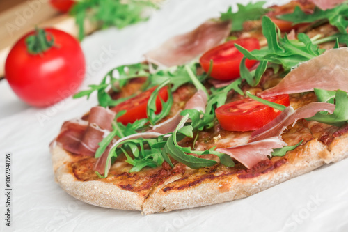 Pizza with Porsciutto, cherry tomatoes and rocket salad