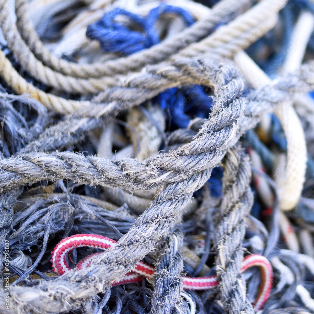 Weathered, old nautical ropes. Stack of ropes, close-up of nautical vessel. 