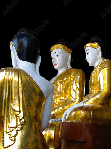 Gold and white Buddha statues at the Shwedagon Pagoda in Yangon,