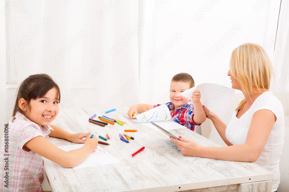 Mother and daughter and son at home at the table.. Mother and daughter and son at home at the table..