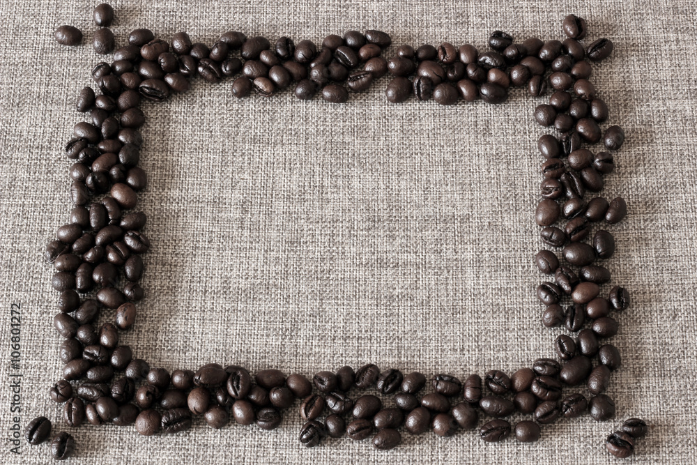 Frame made of coffee beans on sack cloth background. Frame made of coffee beans on sack cloth background.
