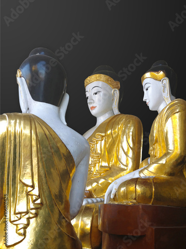 Gold and white Buddha statues at the Shwedagon Pagoda in Yangon,
