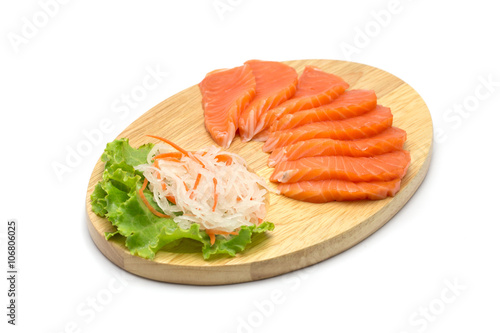 Sliced salmon on wood background and isolated on white backgroun