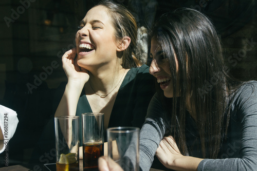 Women laughing and having fun in a bar