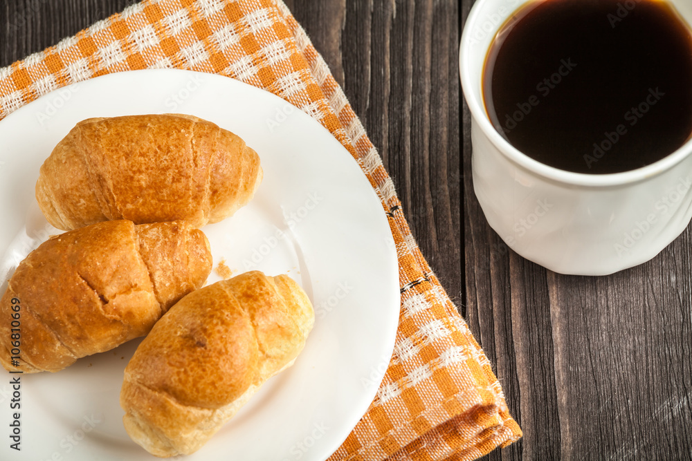 small croissants and cup of coffee