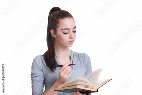 Young beautiful girl reading a book and thinking