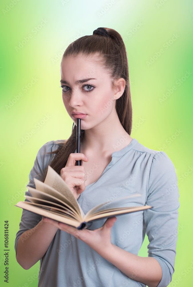 Young beautiful girl reading a book and thinking Young beautiful girl reading a book and thinking