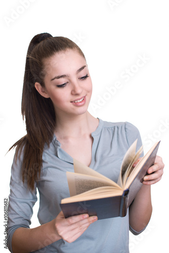 Young beautiful girl reading a book and smiling