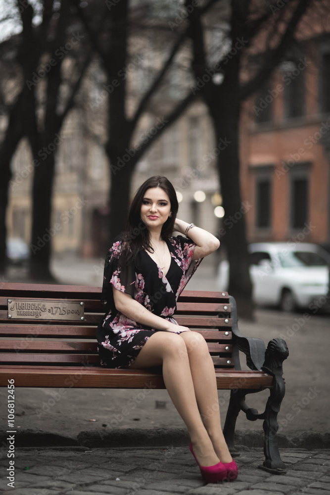 Fototapeta premium Beautiful brunette young woman posing on the street in old city