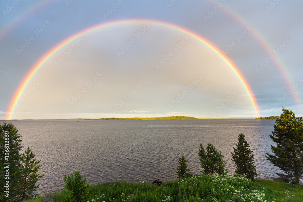 Naklejka premium Double colorful rainbow over the lake