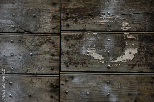 old medieval wooden dark gray planks of gates with peeling paint photo